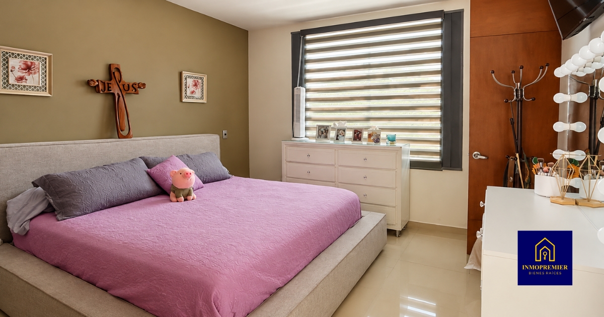Recámara con cama, persianas y tocador iluminado